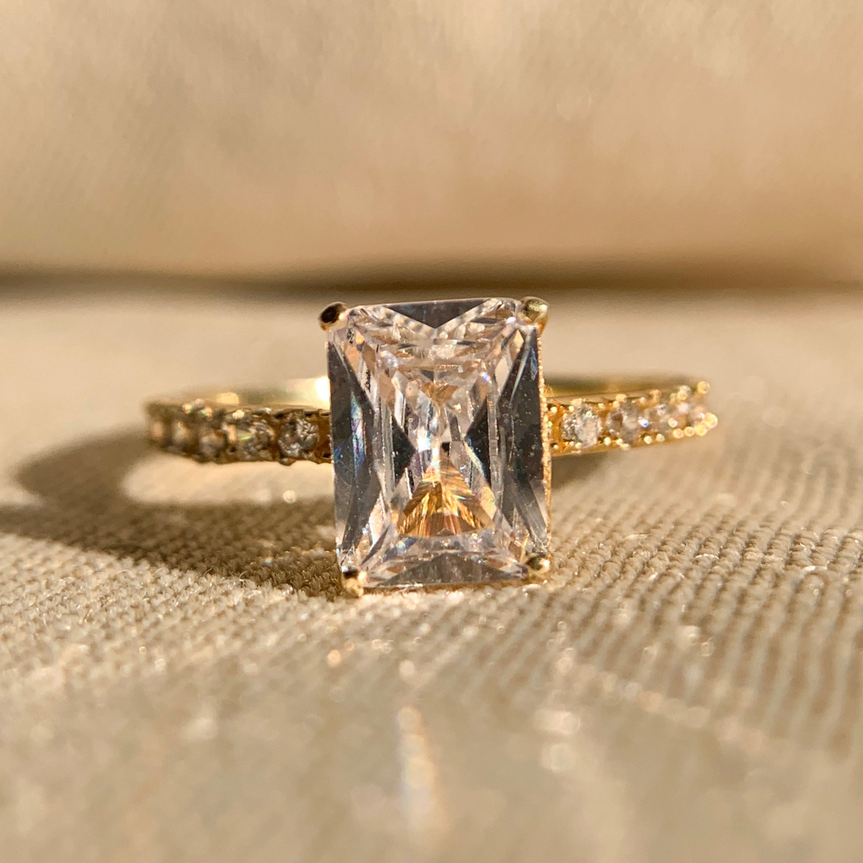 “1.0 CT radiant cut diamond engagement ring with sparkling side stones in classic setting”